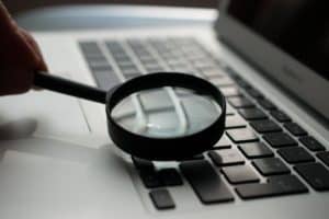 Website seo check magnifying glass one a laptop
